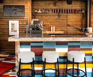 colorful bar seating area and coffee machine